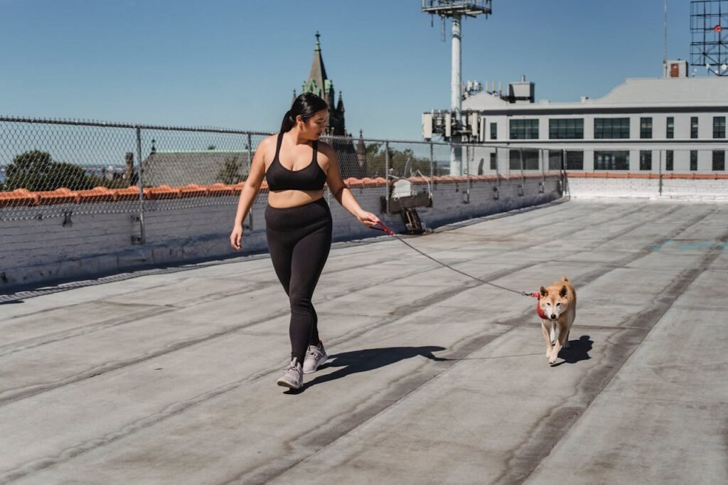 a women with her dog in sunny morning